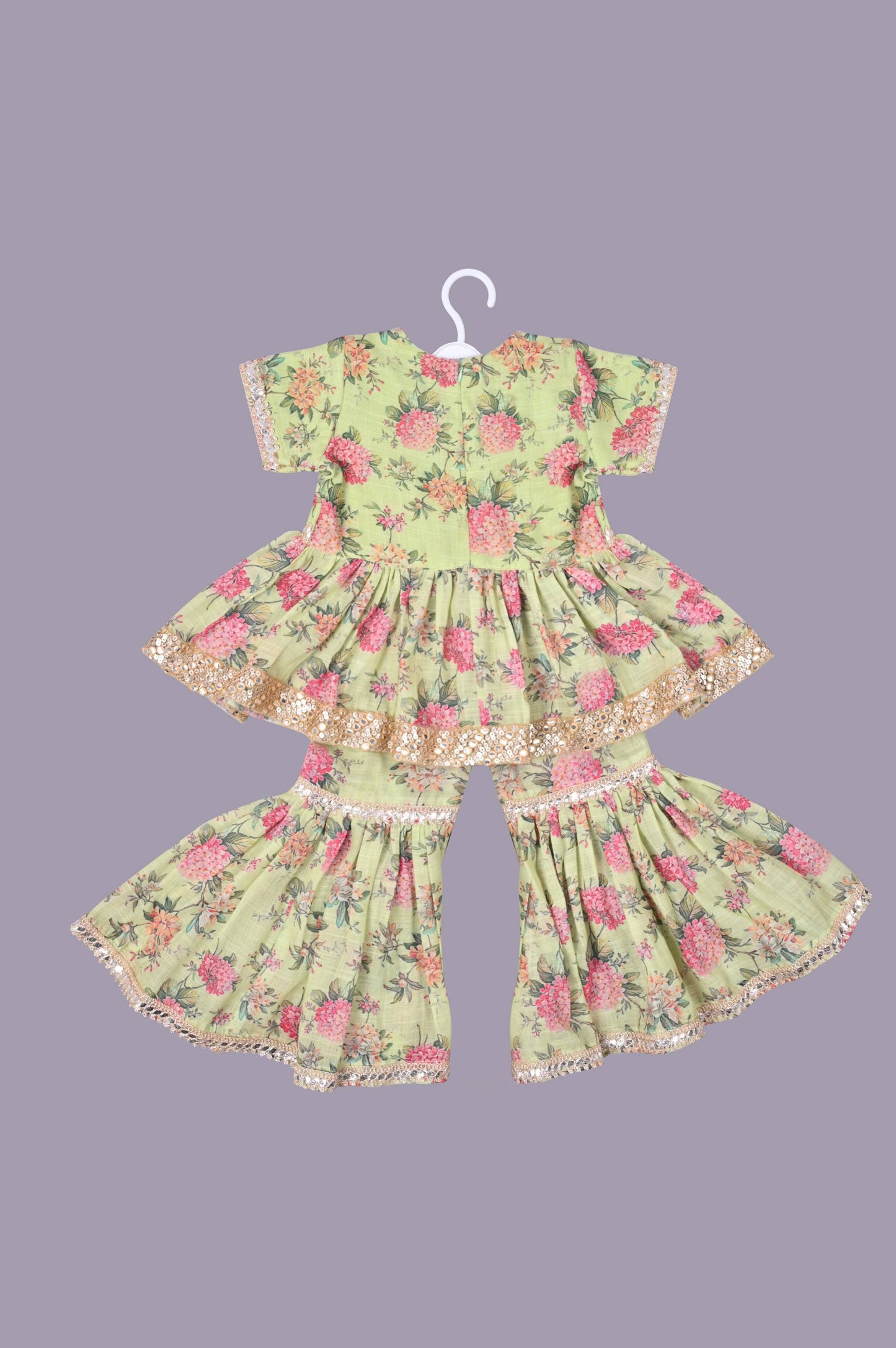 Vibrant floral cotton linen peplam kurti adorned beautifully with laces alongwith a lovely sharara